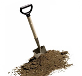 Shovel Stuck In The Top Of A Pile Of Dirt