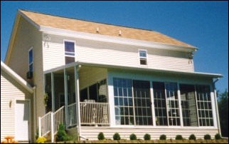 Outside Of An Enclosed Front Porch With FLoor To Ceiling Windows.