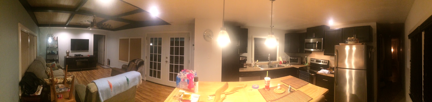 Panoramic Picture Of A Living Room, Dining Room and Kitchen.