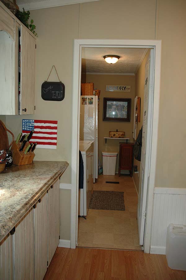 Laundry Room With New Tile Flooring, Painted Walls And Storage In Place Of The Door.
