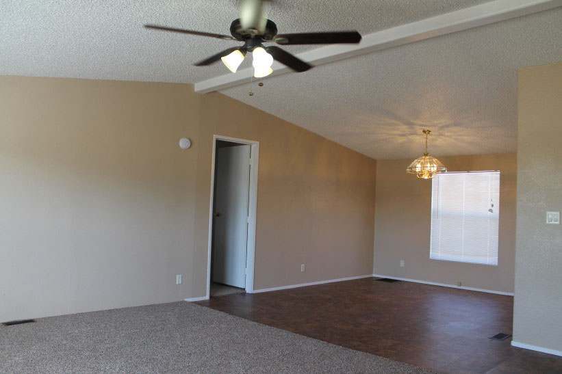 Large open Room With New Carpet And Tiling And Painted And Repaired Walls.