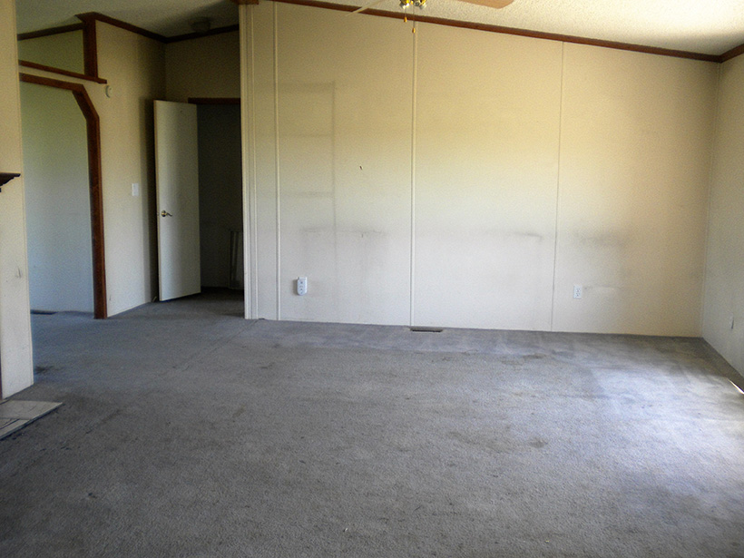 Living Room With Grey White Carpet And White Stained Walls. 