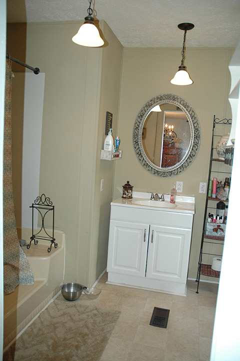 Updated Bathroom With Painted Walls, A New White Cabinet Under The White Sink And Tile Flooring.