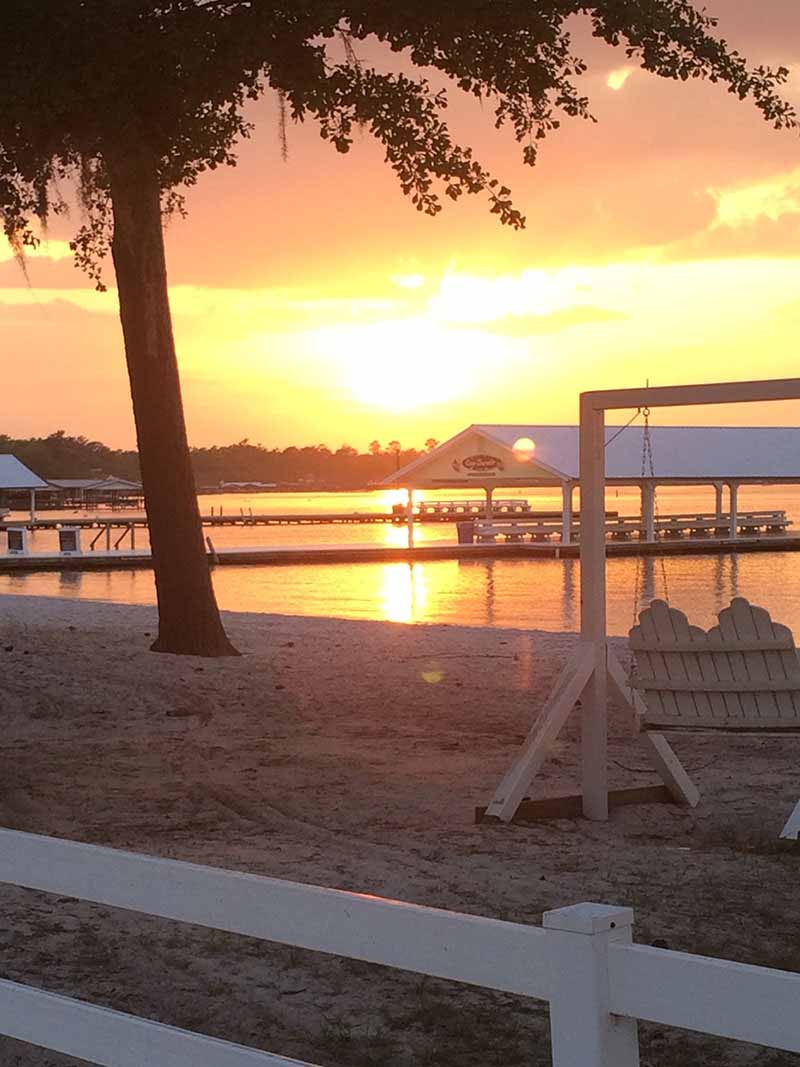 Sunset On A Beach With A Dock.