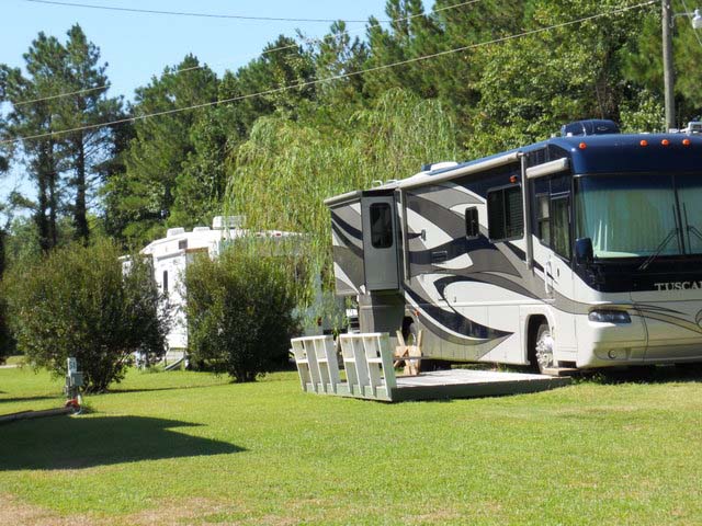RV Parked With A Porch Outside.