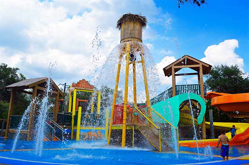 Children Playing In A Water Park.