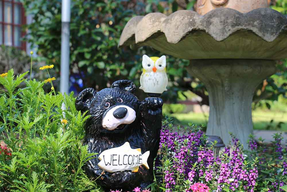 Bear Statue In A Garden.