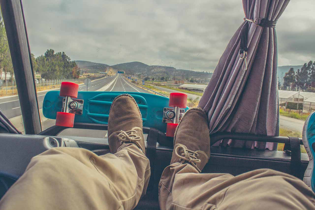 Feet On A Dashboard With The Open Road Ahead.