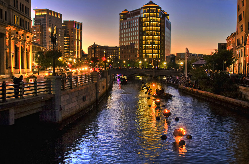 River In Providence, Rhode Island During A Festival, With Flaming Lanterns In the Water.