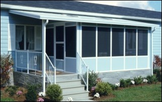 Blue Mobile Home With A Screened In Front Porch